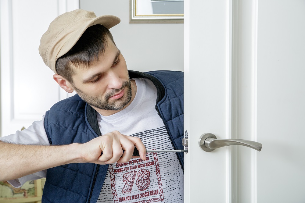 Fixing lock. Serrurier. Kevin Locksmith. Locksmith man. Locksmith stock image.